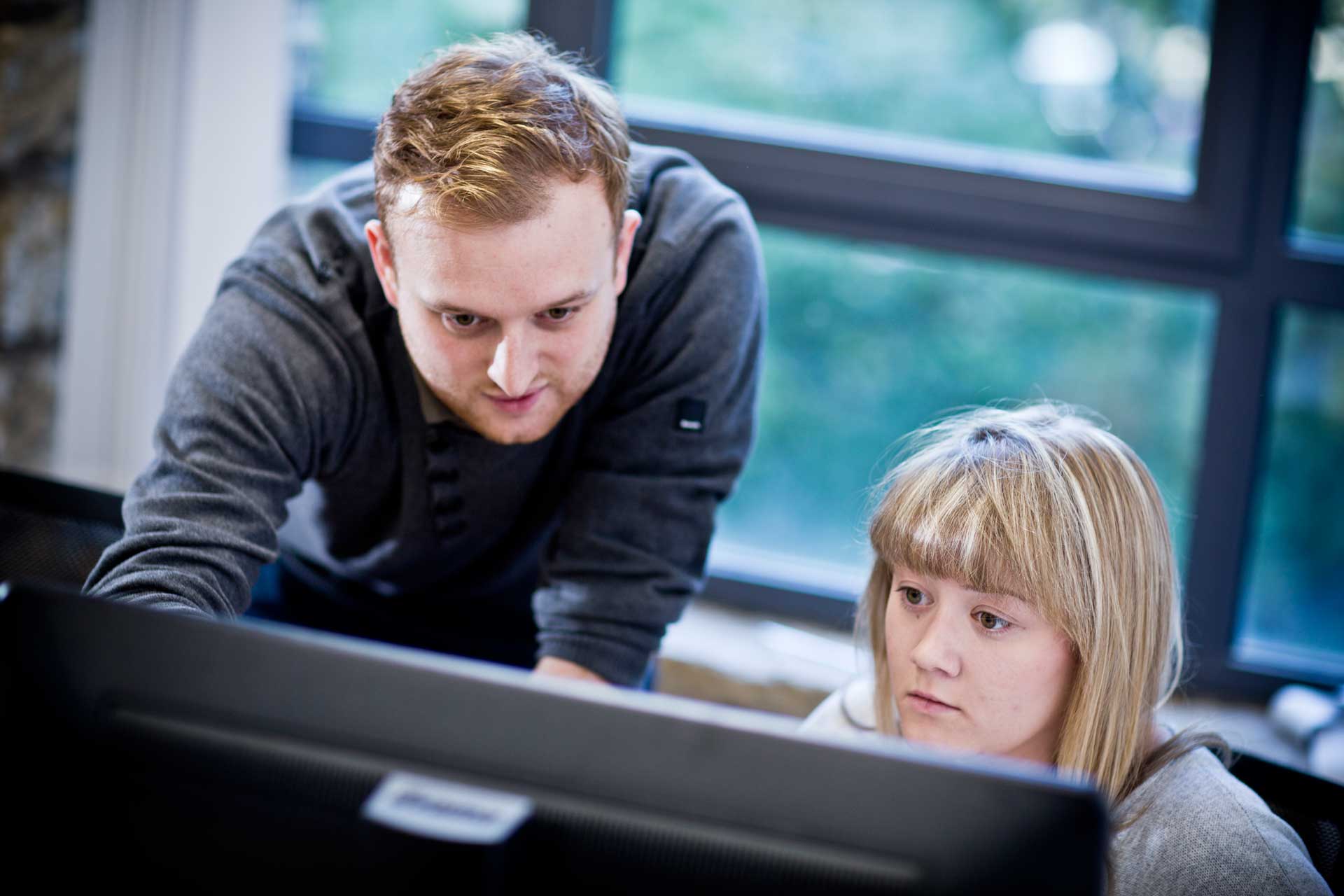 Student being taught be lecturer at PC