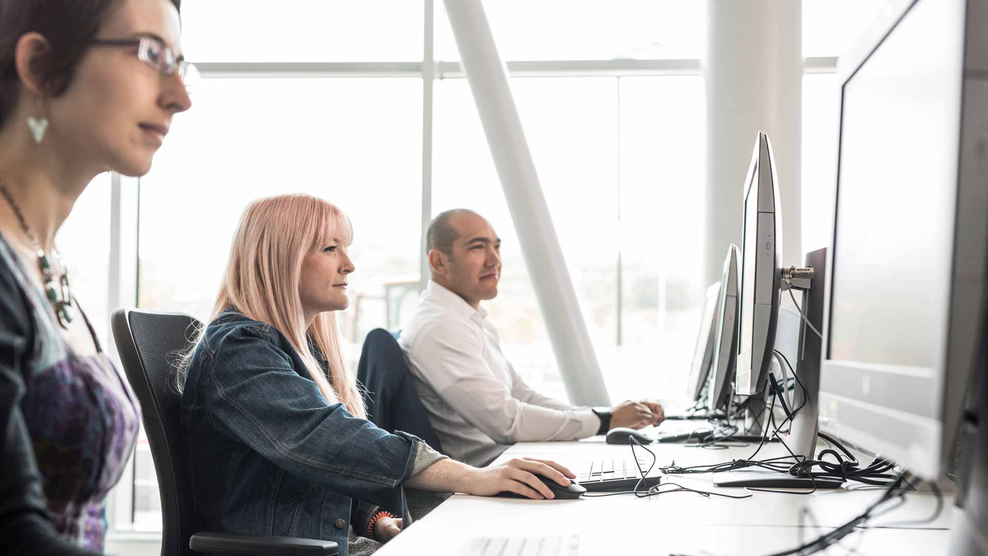 Staff using computers in The Oastler Building
