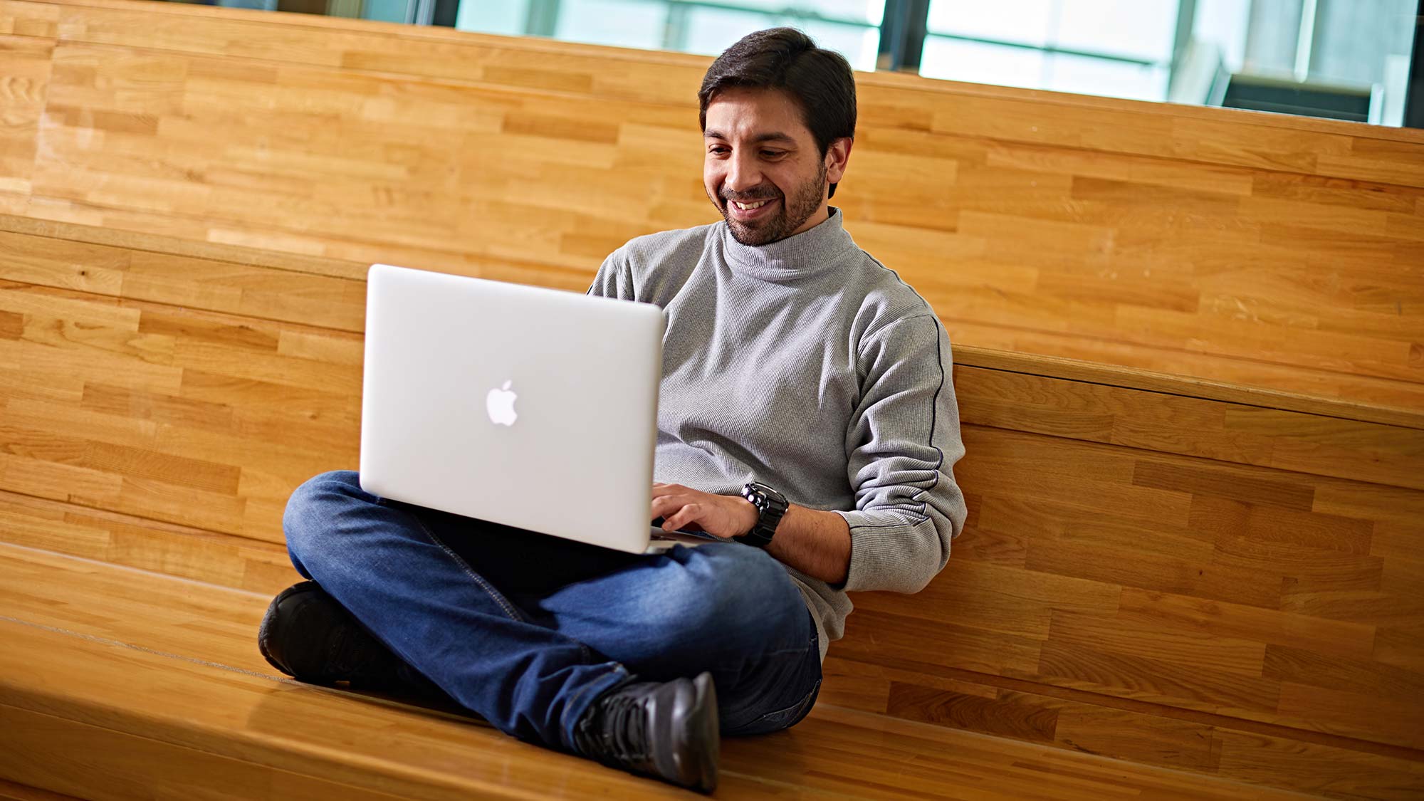 A student using a laptop in the Oastler Building