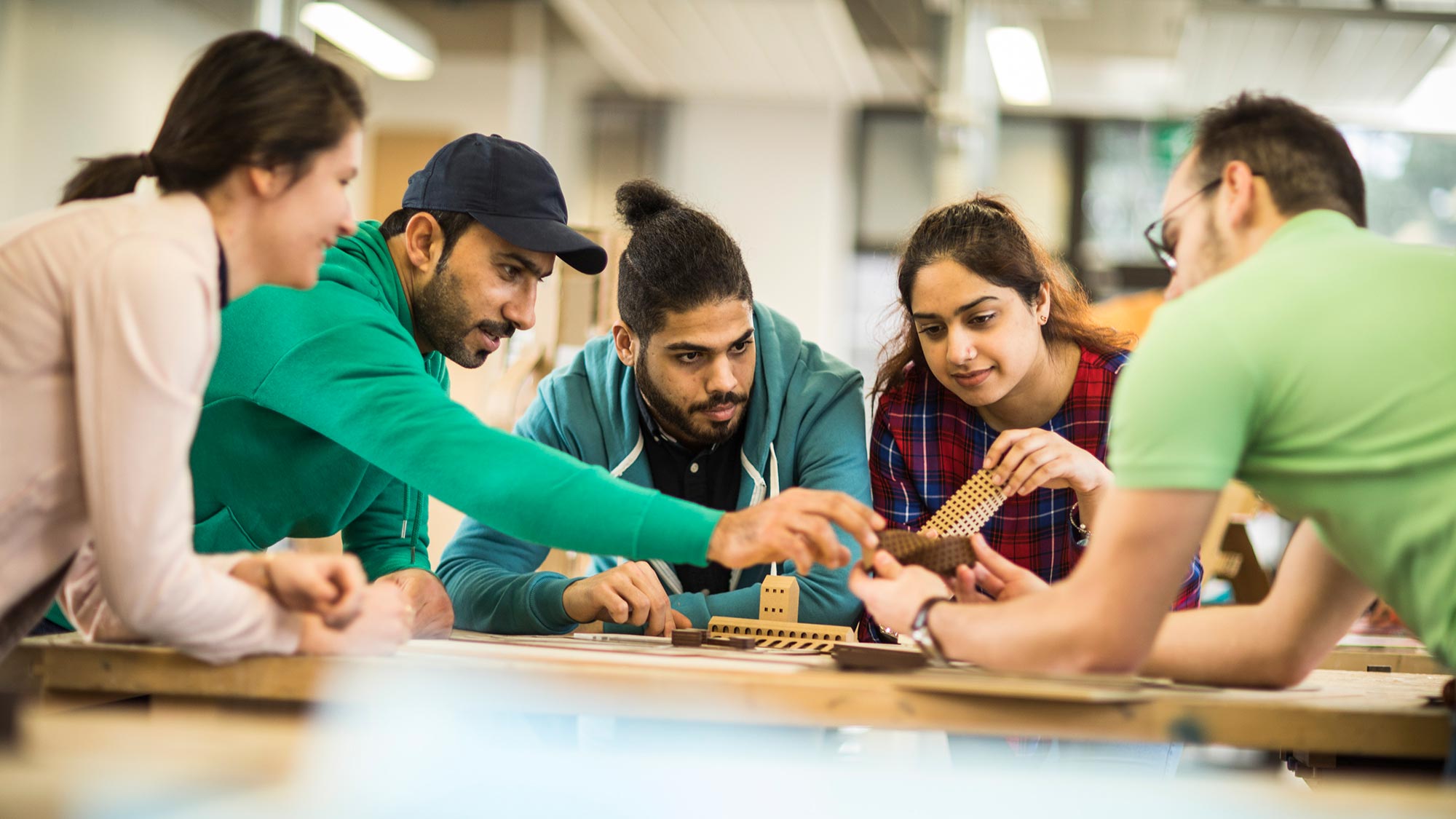 Students looking at models in the School of Arts and Humanities
