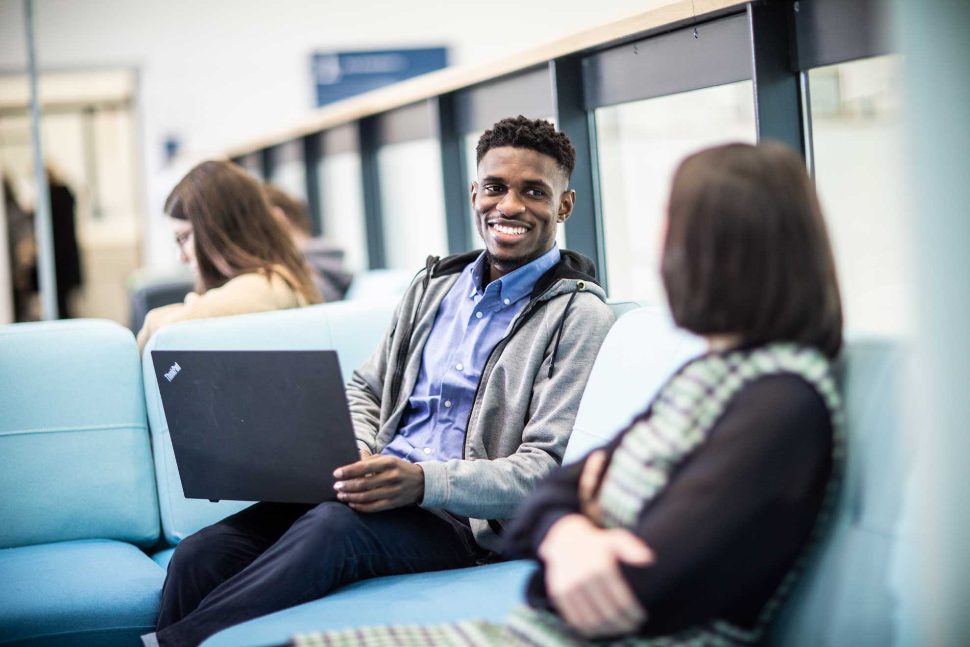 Man smiling with laptop
