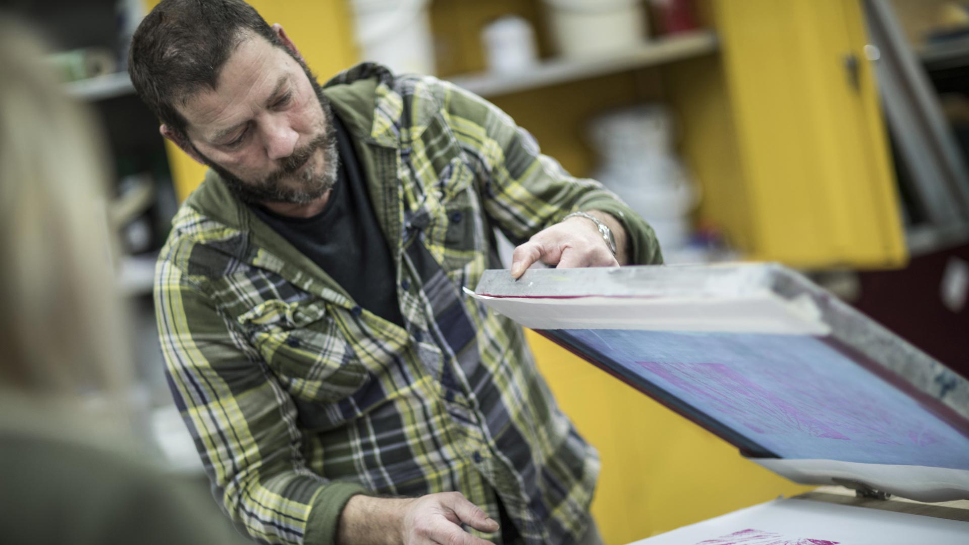 A photo of someone using a printing press